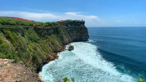 Towards the edge of the cliff overlooking the cliffs and the blue ocean. Stock Footage 122126734