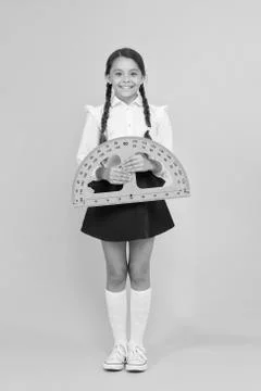 Towards knowledge. happy small school girl study geometry. student use Stock Photos