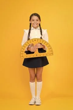 Towards knowledge. happy small school girl study geometry. student use 스톡 사진