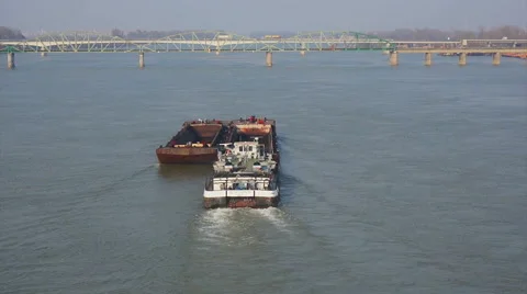 Towboat with two barges and two bridges in distance aerial shot Stock Footage 49588832