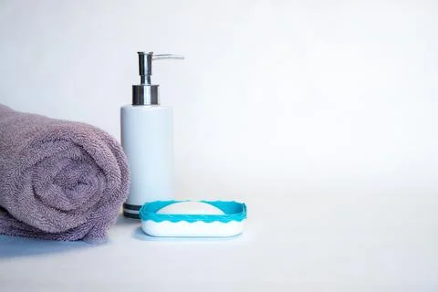 A towel and liquid and solid soap on a white background. Place for text. Stock Photos