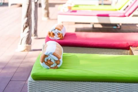 Towel on bed around swimming pool in hotel resort Stock Photos