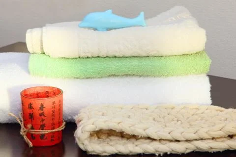 Towel stack and bast in shower. Stock Photos