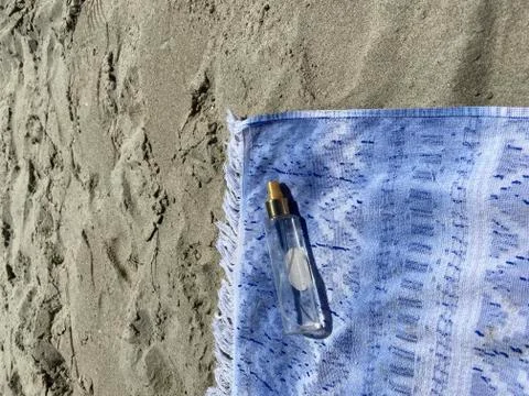 Towel standing on the sand 写真素材
