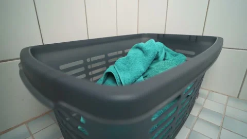 Towels being thrown to a laundry basket. Housekeeping. Housework. Wide Stock Footage 170811116