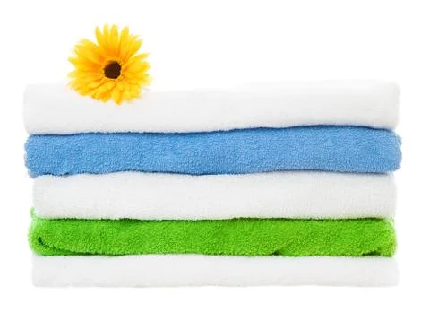 Towels stack with flower on isolated white background Stock Photos