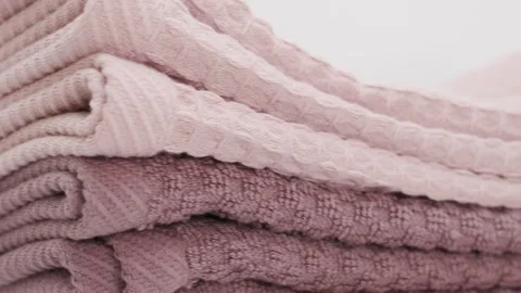 Towels stacked on each other in soft shades at home space. textures patterns 스톡 동영상 332210794