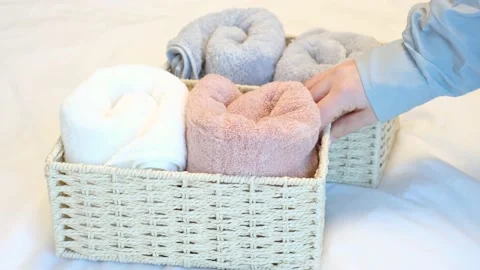 Towels in wicker containers on white background close-up side view, space Stock Footage 234492346