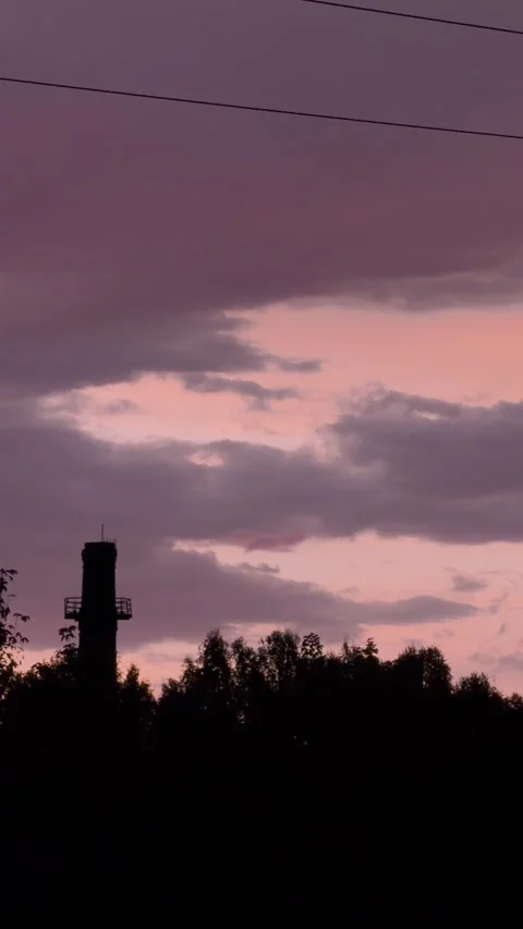 Tower and Tree Silhouettes Beneath Pink Sunset Clouds Stock Footage 344957350