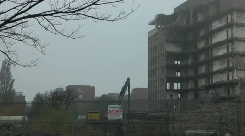 Tower block during demolition, forlorn amongst piles of rubble Stock Footage 14775372