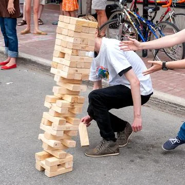 Tower of blocks game tumbles Stock Photos
