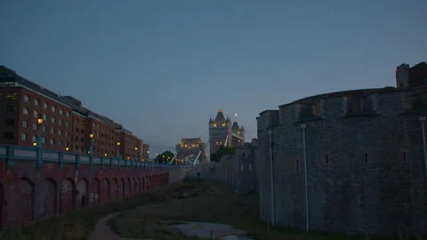 Tower Bridge at dusk seen beyond the Tower of London’s stone walls. Stock Footage 321607350
