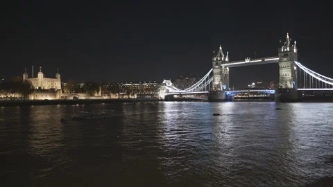 Tower Bridge illuminated at night by city lights Stock Footage 319955097