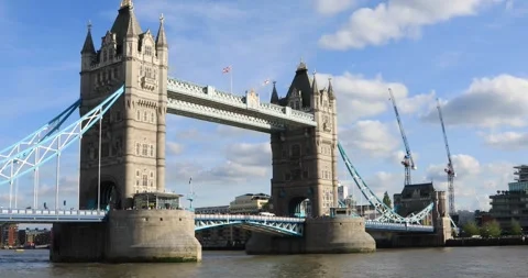 Tower Bridge over the River Thames in afternoon sun with flags and cranes Stock Footage 319793467
