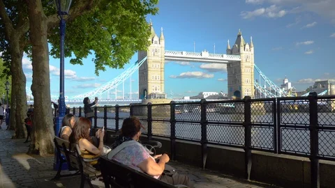 Tower Bridge - People Sitting At Pier - London, UK - June, 2018 Stock Footage 96690832