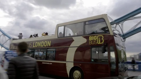 Tower Bridge red tourism bus panning driving across London England UK 4K 1080 HD Stock Footage 92514409