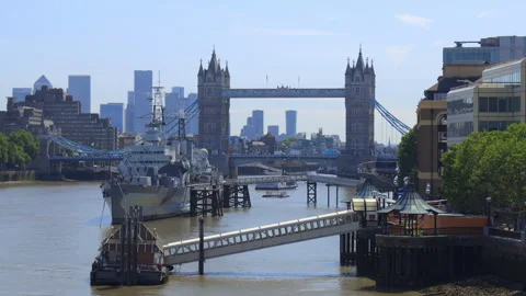 Tower bridge, river Thames and HMS Belfast cruiser boat on a sunny afternoon Stock Footage 321460554