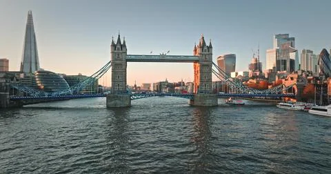 Tower Bridge spanning River Thames with London cityscape at sunset Stock Photos