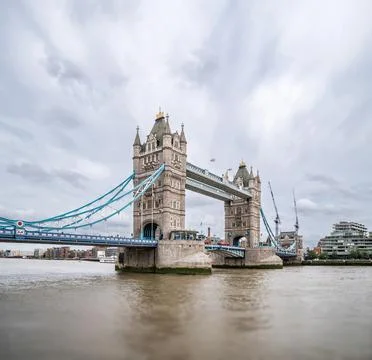 Tower Bridge Spans the Thames with Its Gothic Towers and Blue Cables, Remai.. Stock Photos