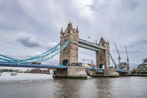 Tower Bridge Spans the Thames with Its Gothic Towers and Blue Cables, Remai.. Stock Photos