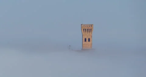The tower of a castle emerges above the fog. Stock Footage 207562453