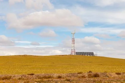 Tower of cellular communication with solar panels Stock Photos