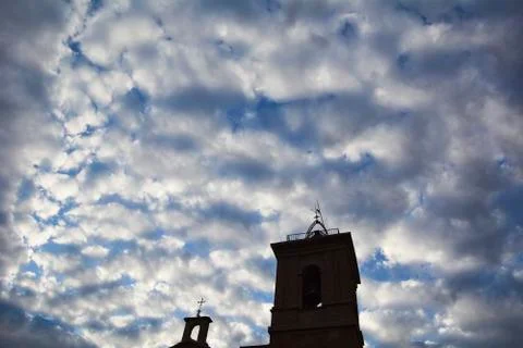 Tower of a church with nice clouds Stock Photos