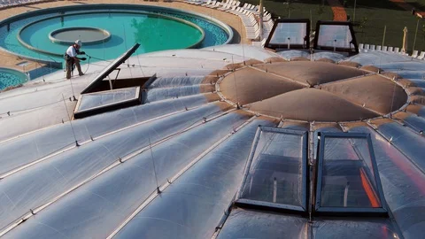 Tower Climber Working on Top of Water Park Building Sunny Day Vídeo Stock 127617455