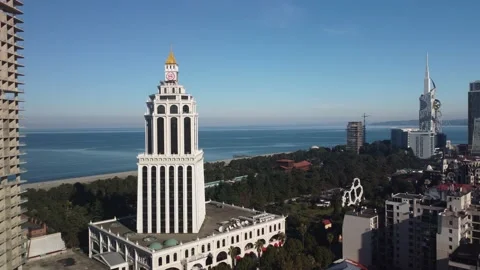 Tower with a clock against the background of the Black Sea. Sheraton district Stock Footage 238034337