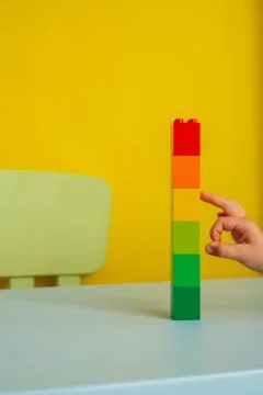 Tower of colored blocks.on a yellow background Stock Photos