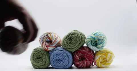Tower of Colorful Yarn Being Stacked High Isolated on White, 4K Stock Footage 66190881