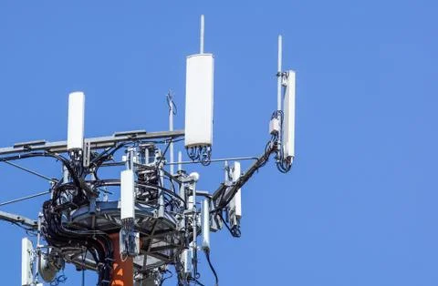 Tower of communications with with a lot of different antennas under clear sky. Stock Photos