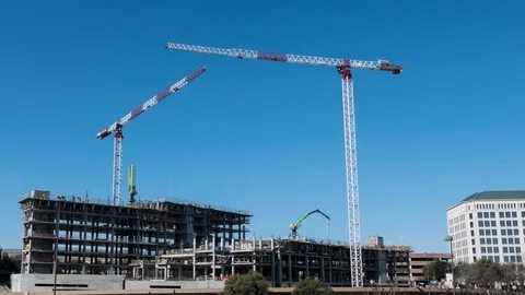 Tower construction cranes moving time-lapse of office tower w/ blue sky Stock Footage 86605754