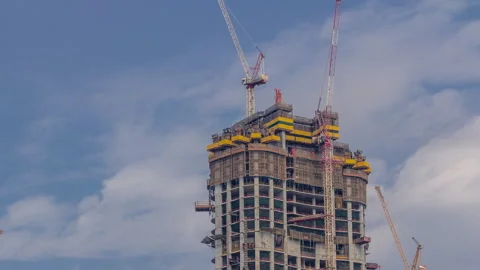 Tower construction site daytime timelapse Dubai with rooftop cranes aerial Stock Footage 337945587