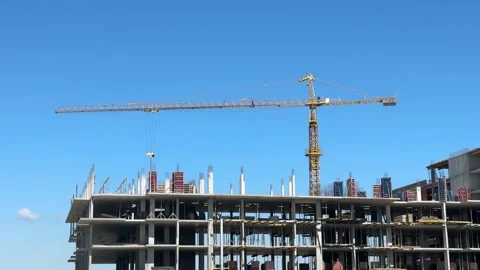 Tower Crane Above Concrete Building Under Construction Against Blue Sky Stock Footage 344034351