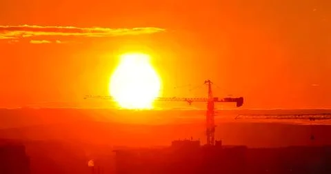 Tower crane against the backdrop of the setting sun. Watercolor illustration. Stock Illustration