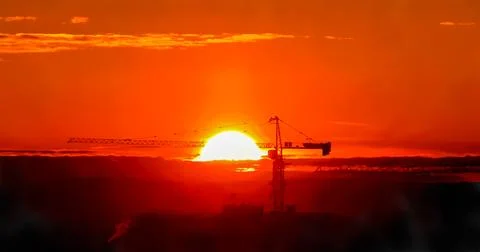 Tower crane against the backdrop of the setting sun. Watercolor illustration. Stock Illustration
