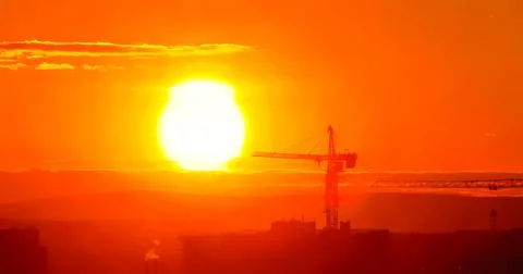 Tower crane against the backdrop of the setting sun. Watercolor illustration. Stock Illustration