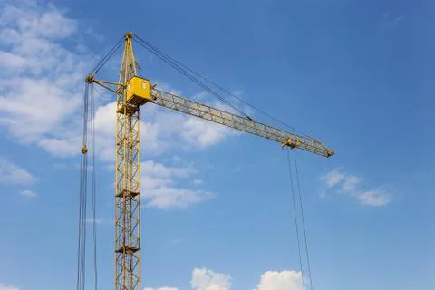 Tower crane against the blue sky. Stock Photos