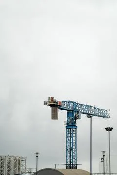 Tower crane against cloudy sky. Warehouse. Stock Photos