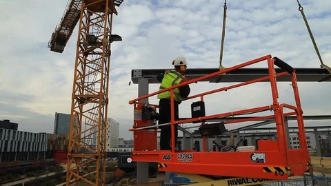 Tower Crane and Construction Crew Placing a Steel Girder in an Building Site Stock Footage 95906966