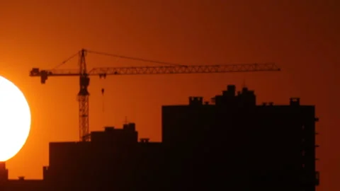 Tower crane behind building in sunset Stock Footage 113519678
