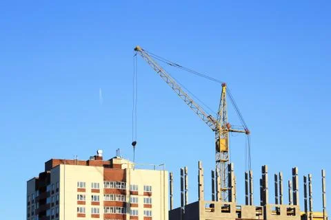 Tower crane on a blue sky background. Stock Photos