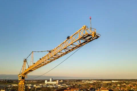 Tower crane on bright blue sky copy space background, city landscape stretchi Stock Photos