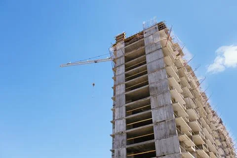 Tower crane at a building site during the construction of blocks of flats.. Stock Photos