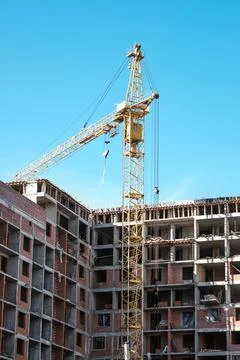 Tower crane at a building site during the construction of blocks of flats. Stock Photos