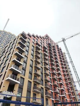 A tower crane builds a skyscraper. An example of an infrastructure construction Foto stock