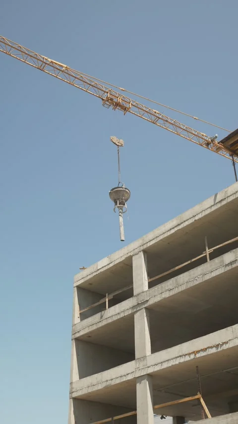 Tower Crane Concrete Bucket and Flexible Drop Chute at Construction Site Stock Footage 346569032