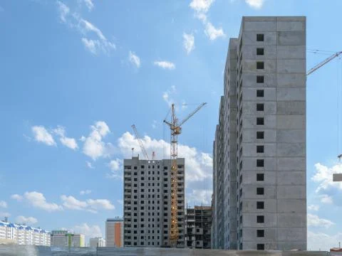 Tower crane on the construction of a new multi-storey house. Side view Stock Photos