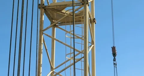 The tower crane at the construction site against the blue sky Stock Footage 104631173